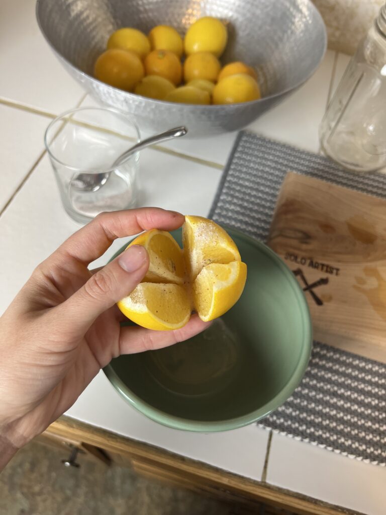 A lemon cut in quarter with salt.