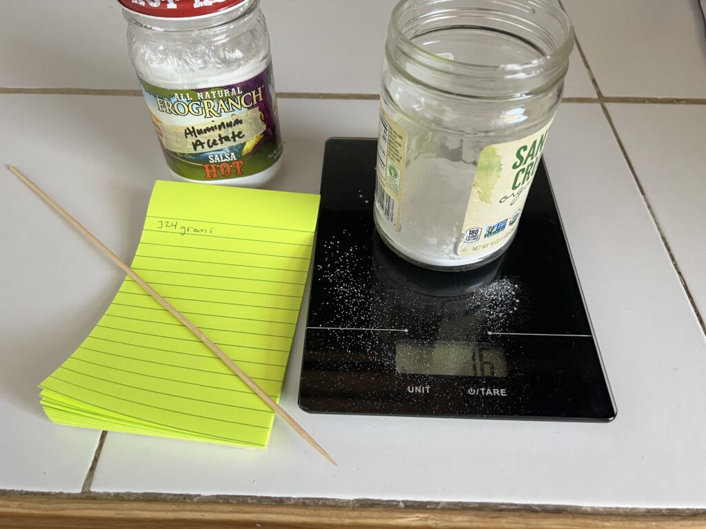Aluminum acetate being weighed in grams.