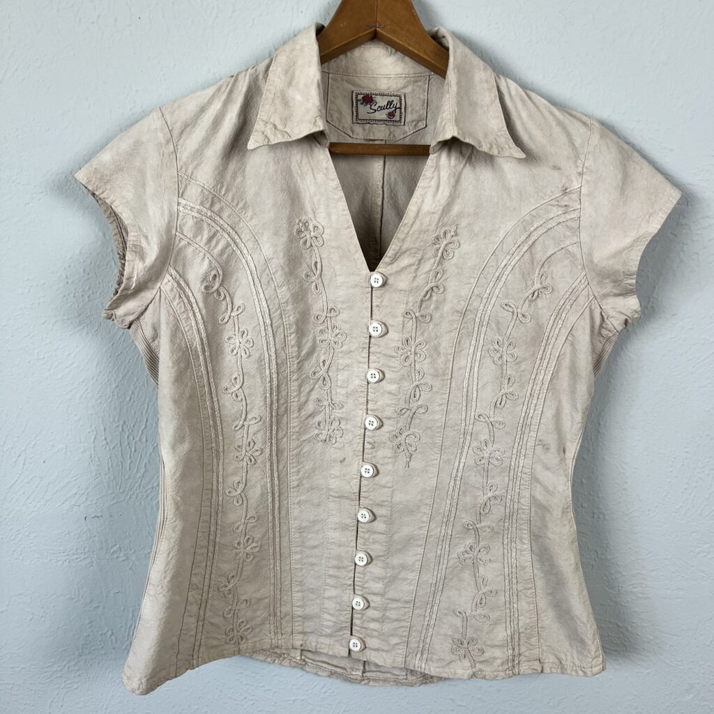 A women's western shirt hanging after being dyed with pecan dye.