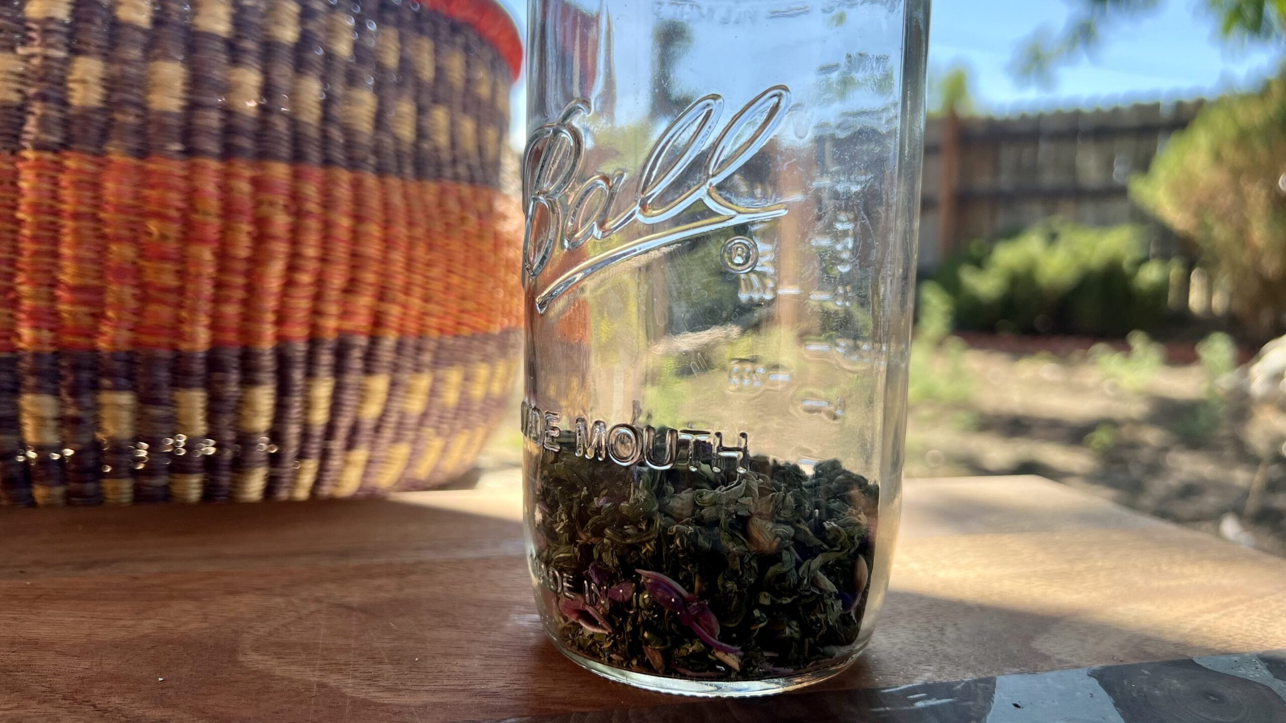 Rolled Fireweed in a jar next to a basket.