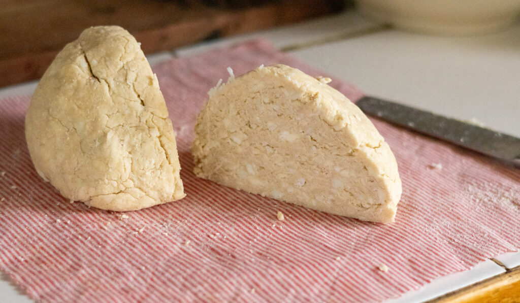Pie dough cut in half, showing the fat chunks.