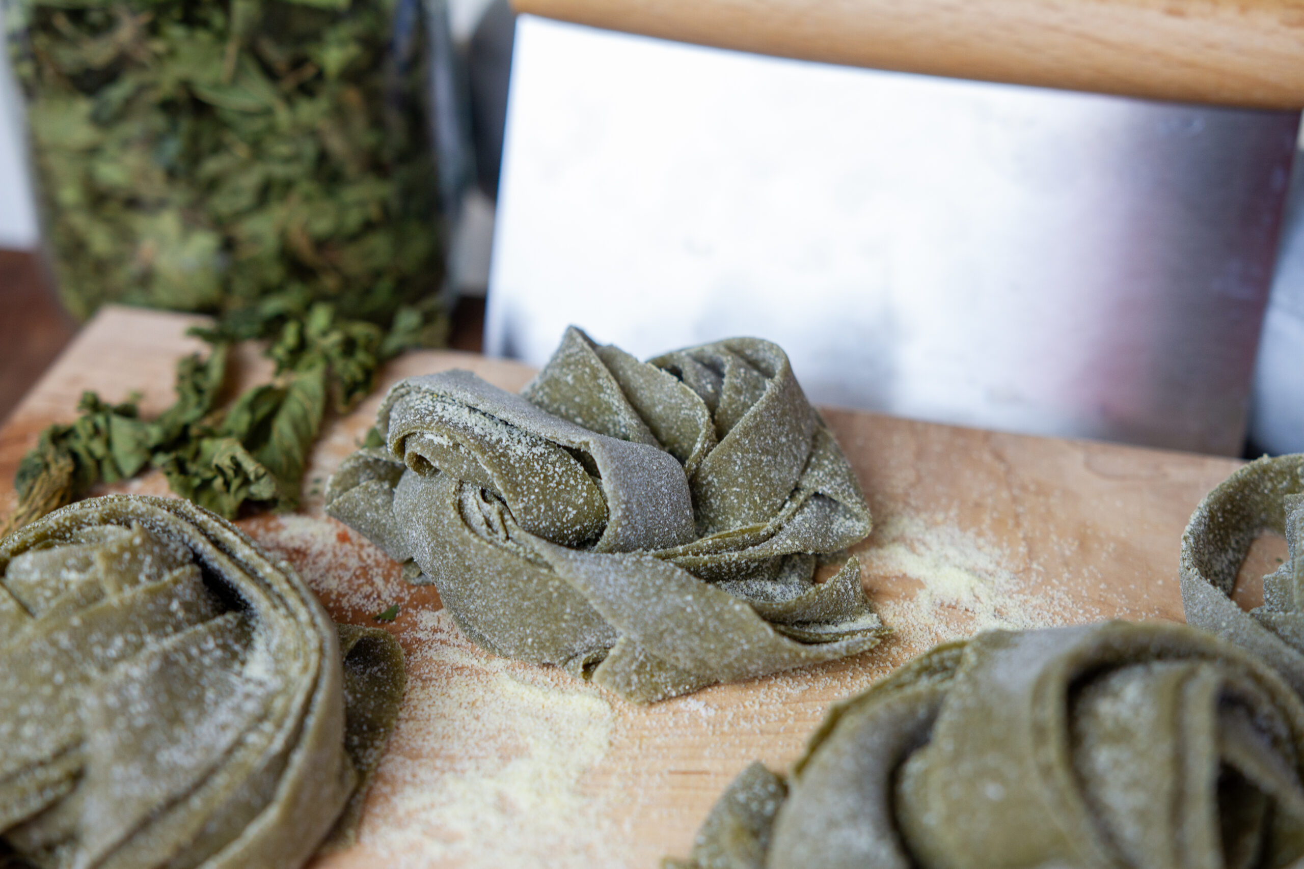A close up of a nest of green dough colored with nettles powder.