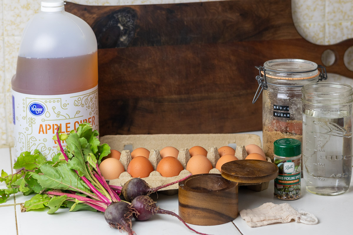 Ingredients for pickled beet eggs on top of a kitchen table.
