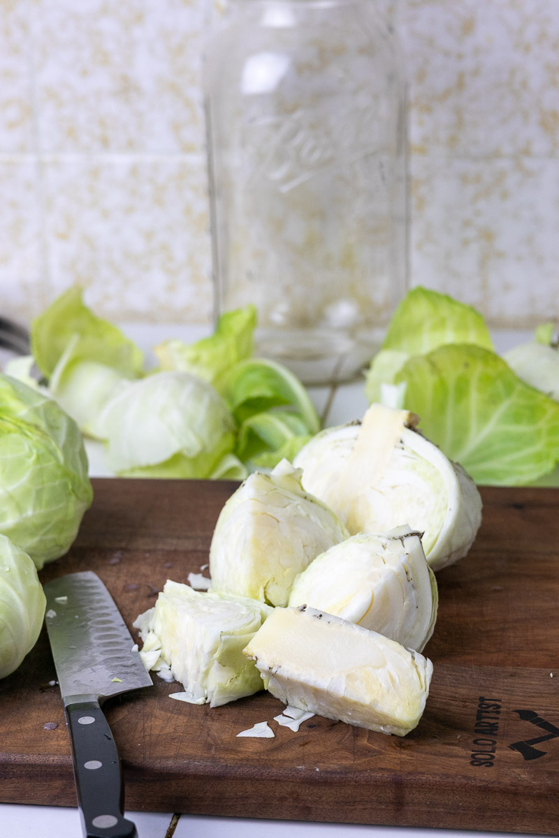cabbage cored and on top of a wood cutting board.