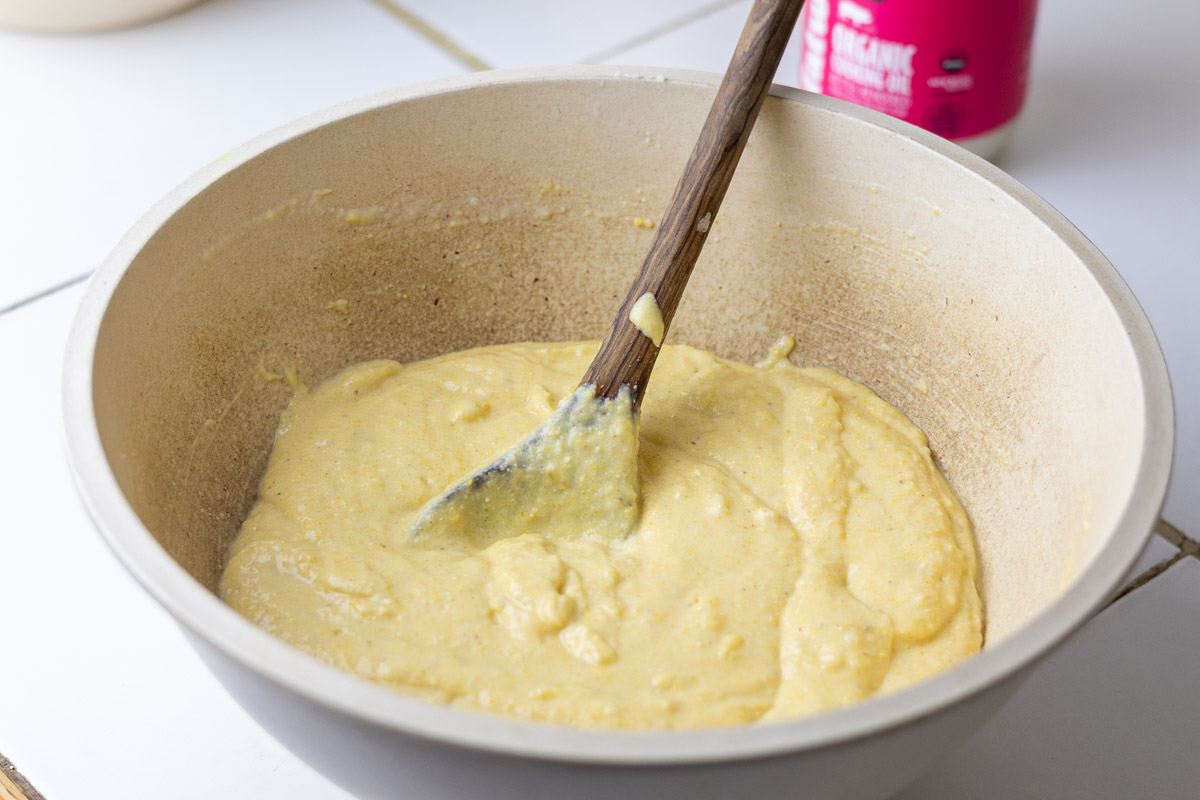 A mixing bowl with lard and gluten free cornbread batter.