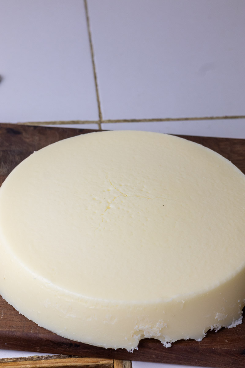 A large disk layer of wet rendered tallow on cutting board.