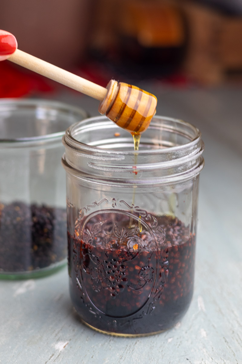 A honey wand putting honey in an oxymel recipe.