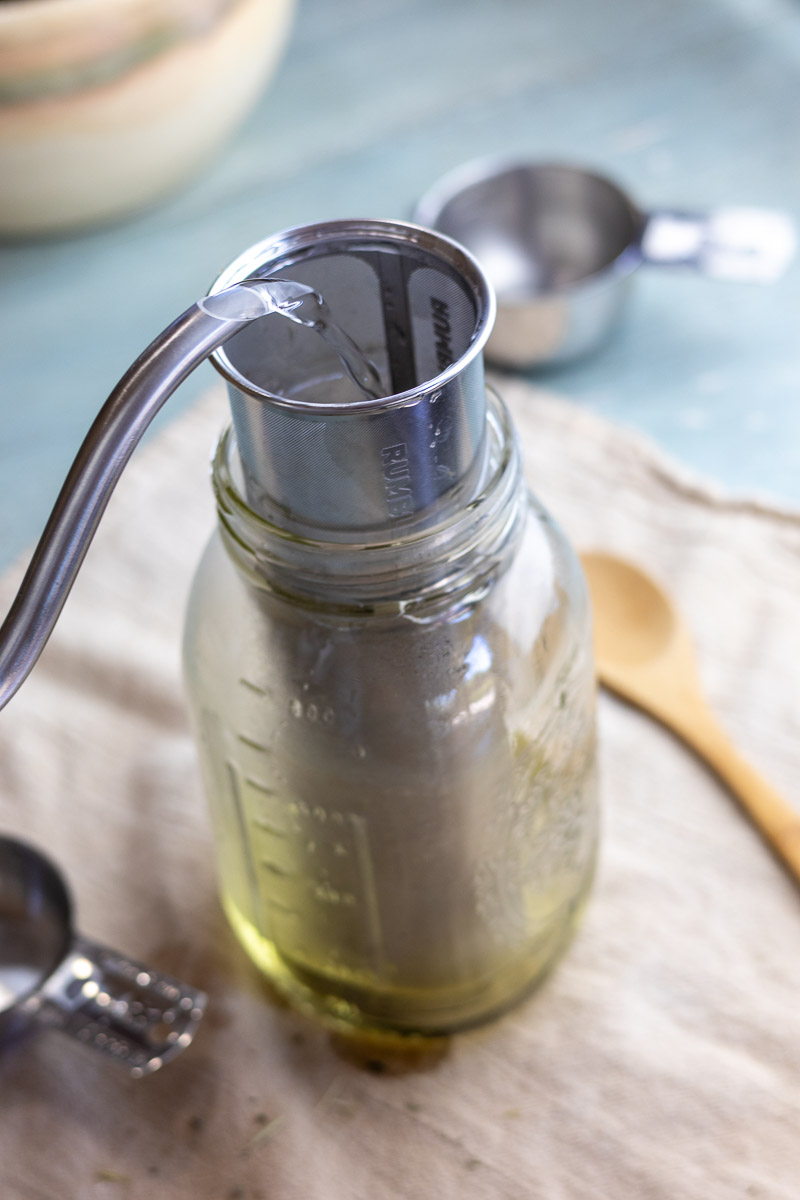 A jar with a rumble jar filled with pregnancy tea blend ingredients preparing for overnight infusion.